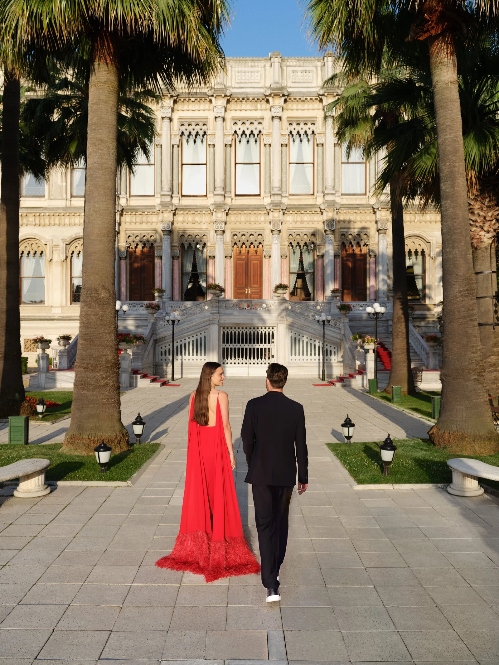 A woman on the palace terrace, the façade and the Bosphorus behind her
