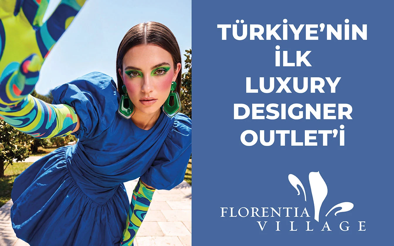 LED screen: a model in a blue dress and green earrings, patterned sleeve raised - “Turkey’s first luxury designer outlet”